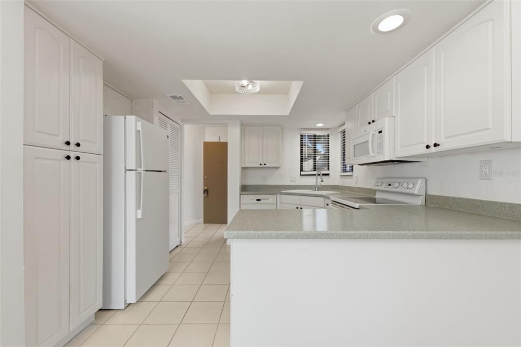141 Spring Wind Way Casselberry, FL 32707 - Photo 15 of 32 a kitchen with stainless steel appliances granite countertop a refrigerator a sink and white cabinets