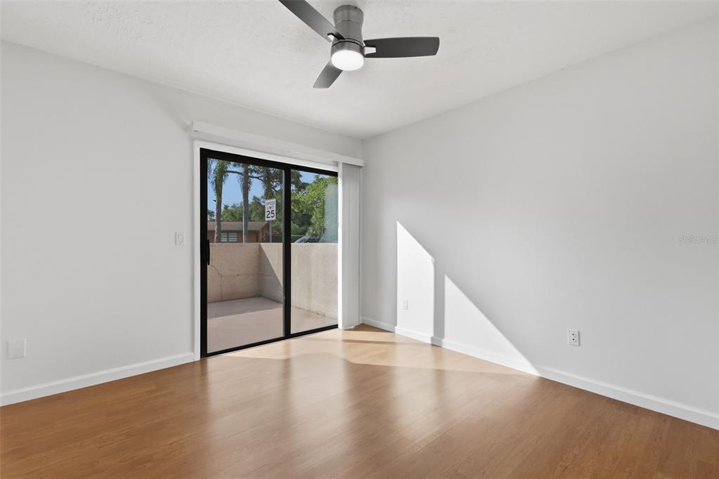 141 Spring Wind Way Casselberry, FL 32707 - Photo 17 of 32 an empty room with wooden floor and windows