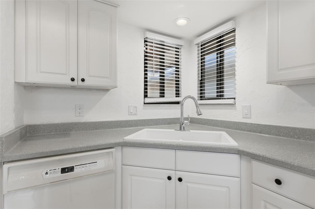 141 Spring Wind Way Casselberry, FL 32707 - Photo 21 of 32 a kitchen with granite countertop white cabinets and a window