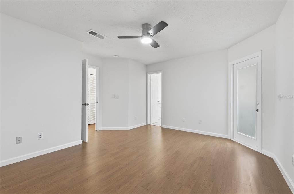 141 Spring Wind Way Casselberry, FL 32707 - Photo 23 of 32 a view of an empty room with wooden floor