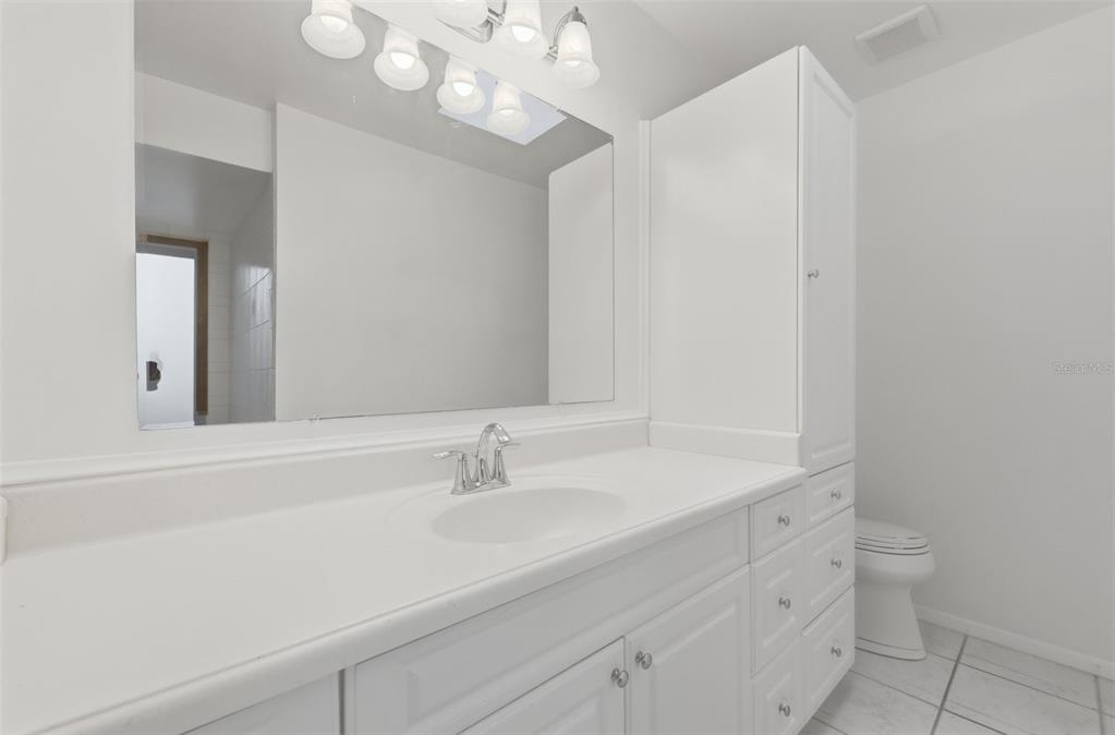 141 Spring Wind Way Casselberry, FL 32707 - Photo 24 of 32 a bathroom with a sink a toilet and a mirror
