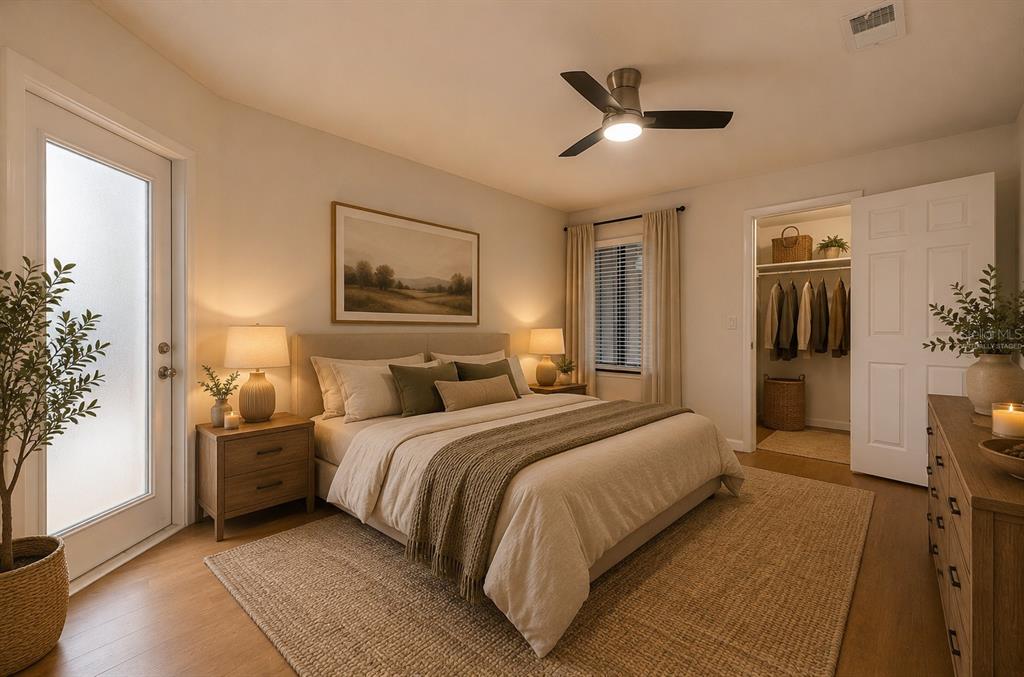 141 Spring Wind Way Casselberry, FL 32707 - Photo 5 of 32 a bedroom with a large bed and a chandelier