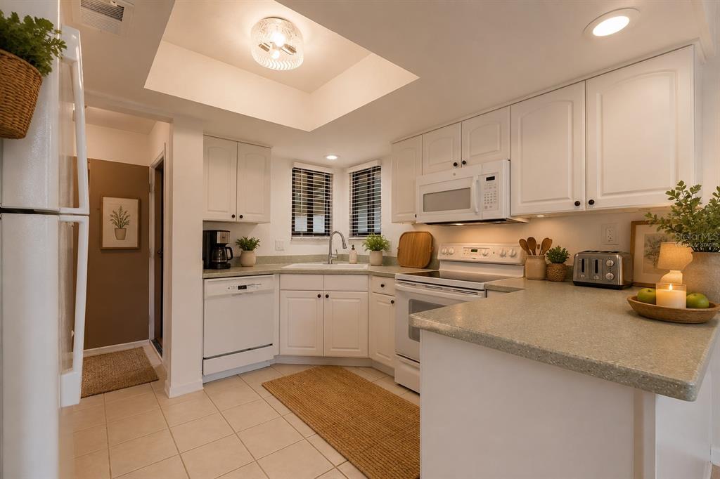 141 Spring Wind Way Casselberry, FL 32707 - Photo 7 of 32 a kitchen with cabinets and stainless steel appliances