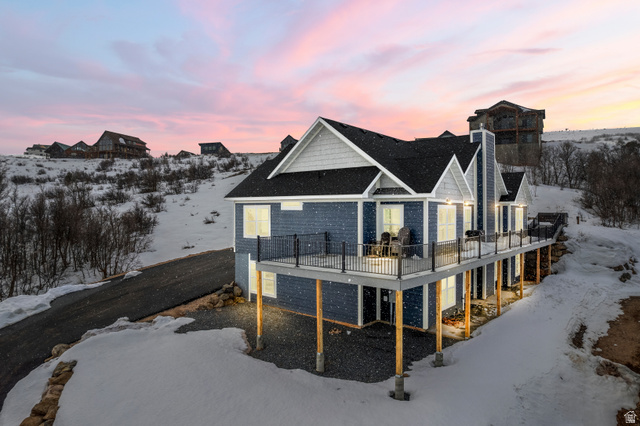 1343 North Trapper Loop Garden City, UT 84028 - Photo 55 of 56 Snow covered property featuring a wooden deck and a chimney