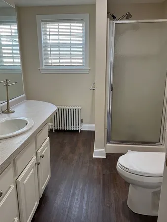 a bathroom with a sink a toilet and a window