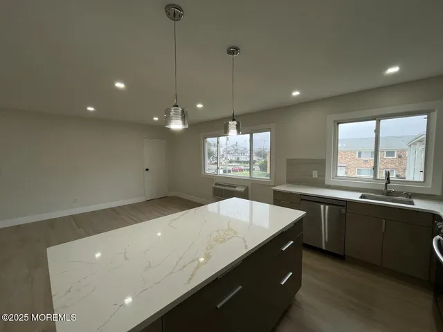 a kitchen with a sink and large window