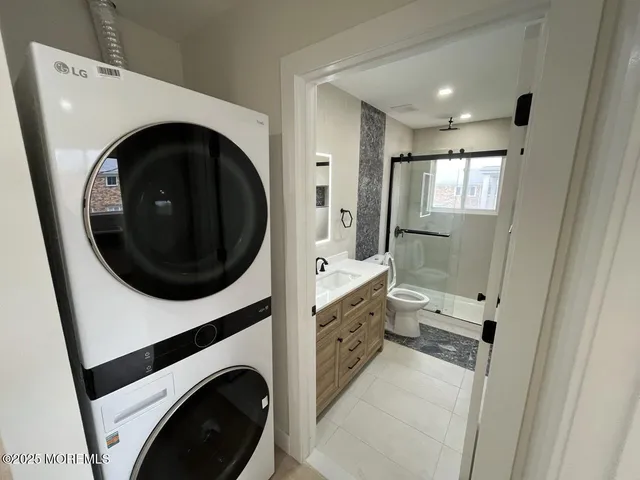 a view of a hallway with washer and dryer