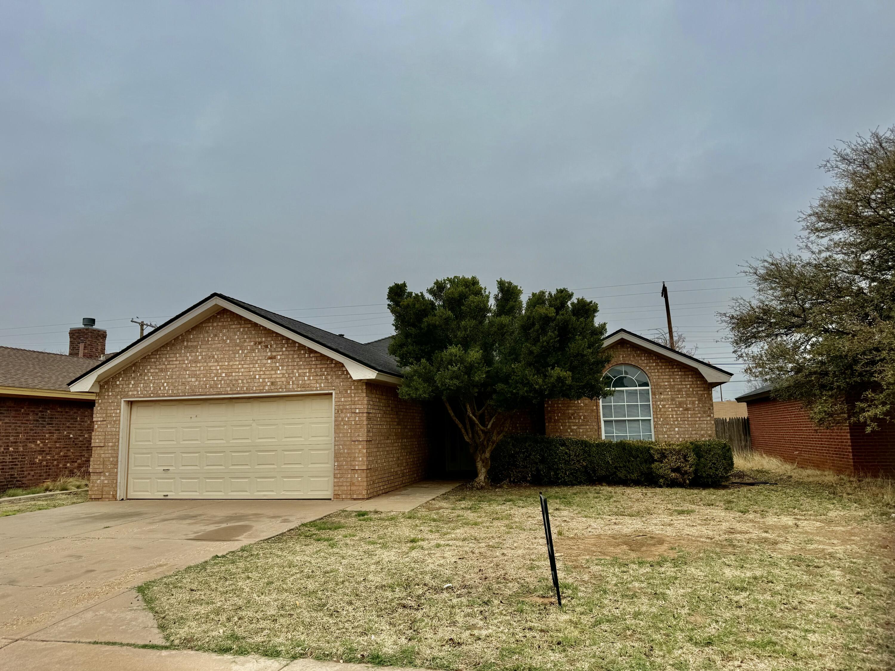 1918 75th Street Lubbock, TX 79423 - Photo 1 of 15 a front view of a house with garden