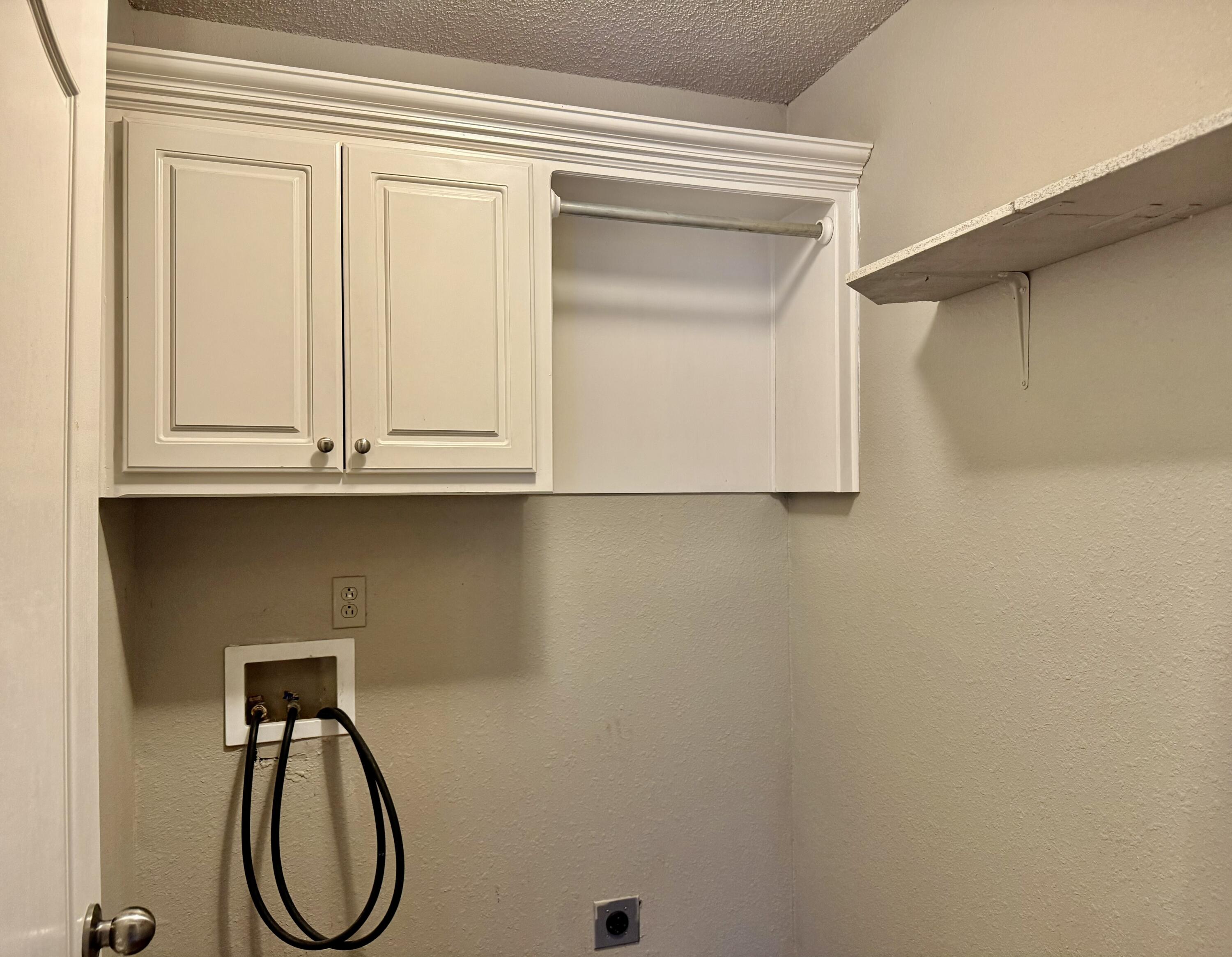 1918 75th Street Lubbock, TX 79423 - Photo 12 of 15 a utility room with a sink and a window