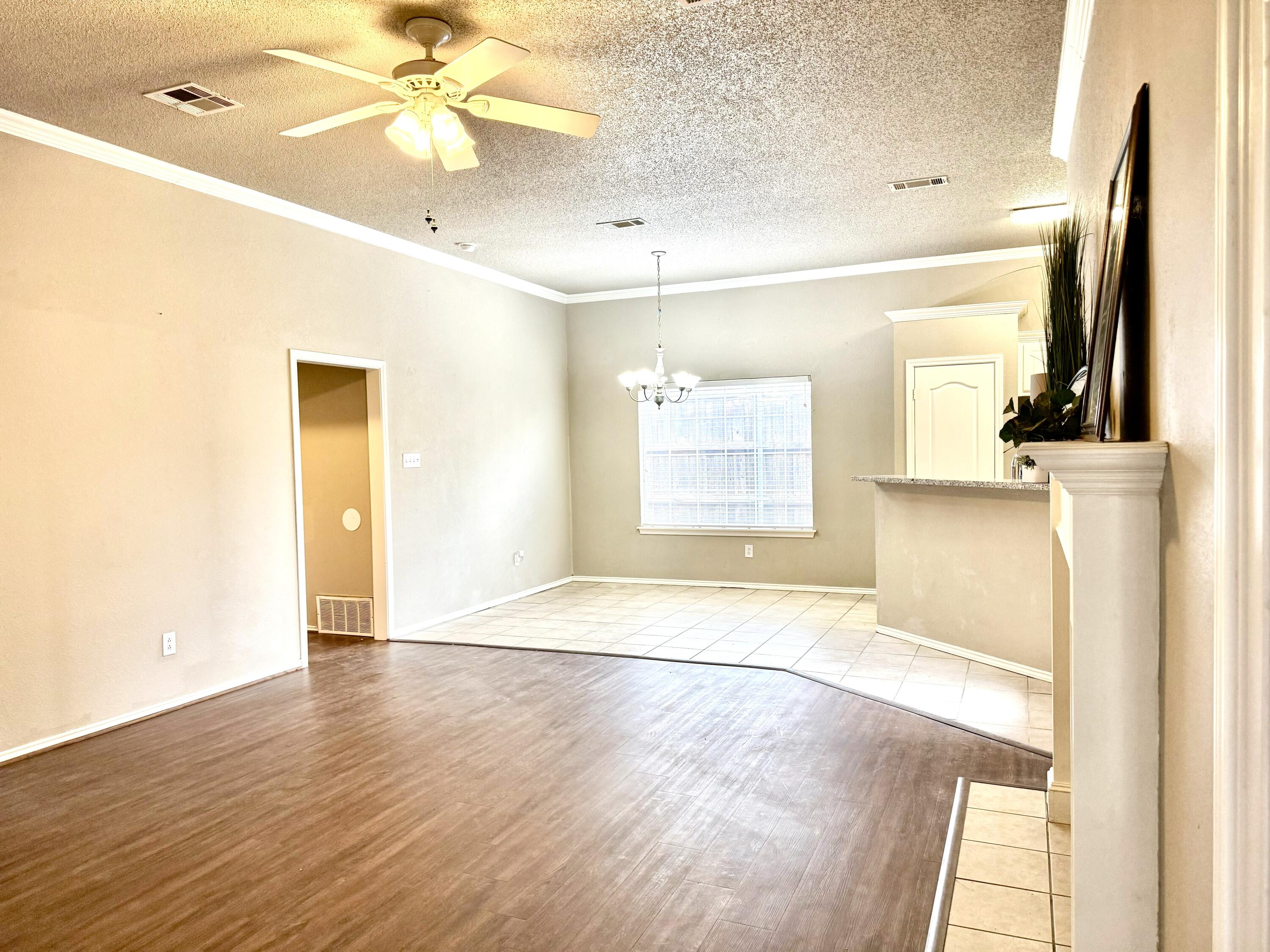 1918 75th Street Lubbock, TX 79423 - Photo 3 of 15 a view of a livingroom with wooden floor and a ceiling fan