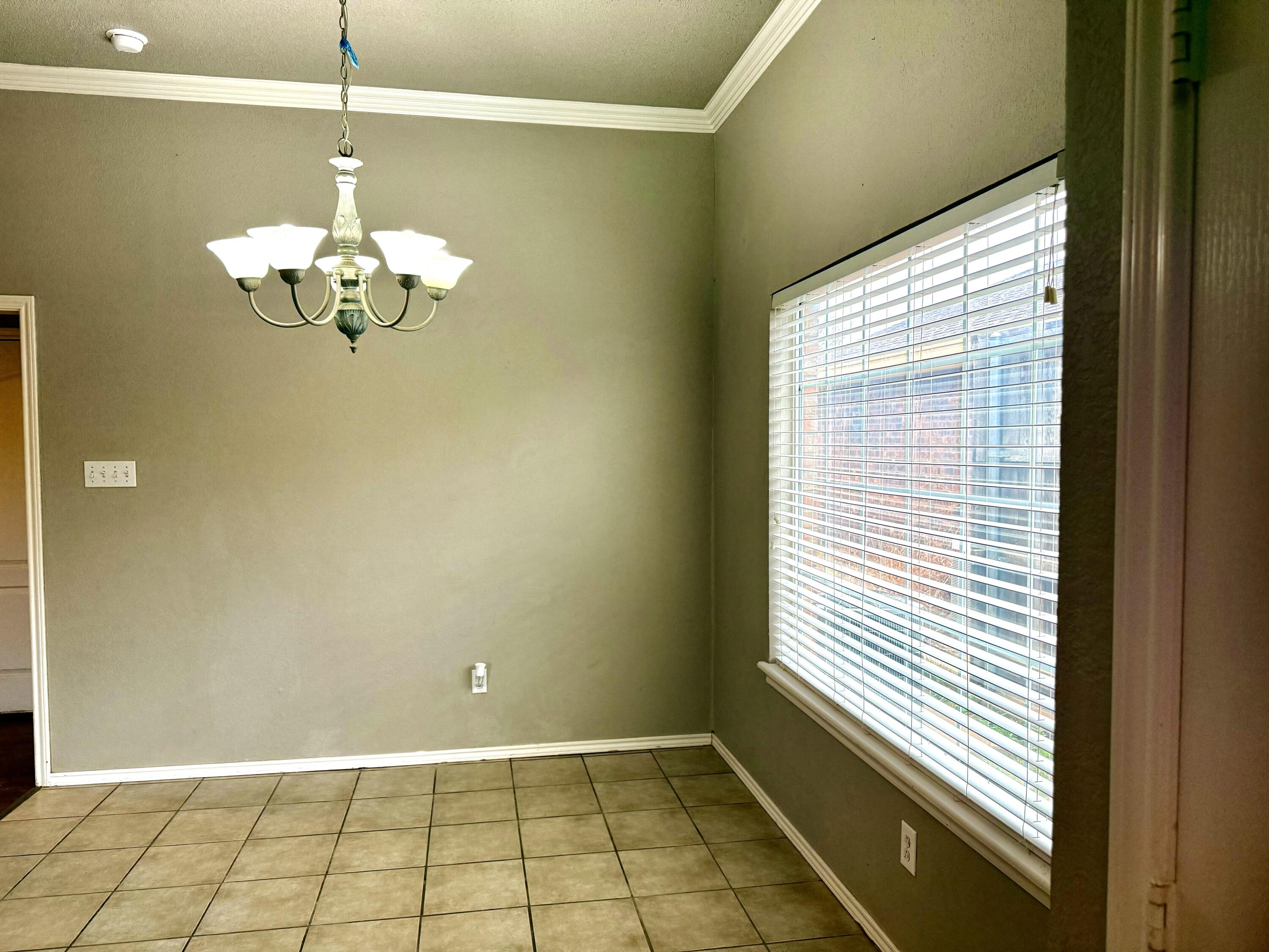1918 75th Street Lubbock, TX 79423 - Photo 5 of 15 a view of a room with a chandelier fan and windows