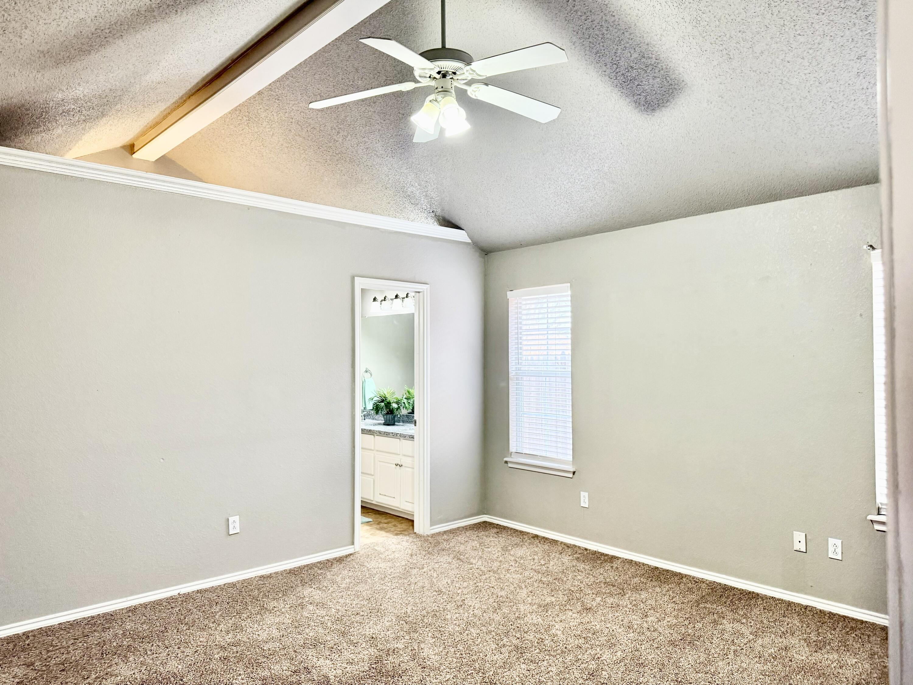1918 75th Street Lubbock, TX 79423 - Photo 6 of 15 an empty room with closet and a chandelier fan