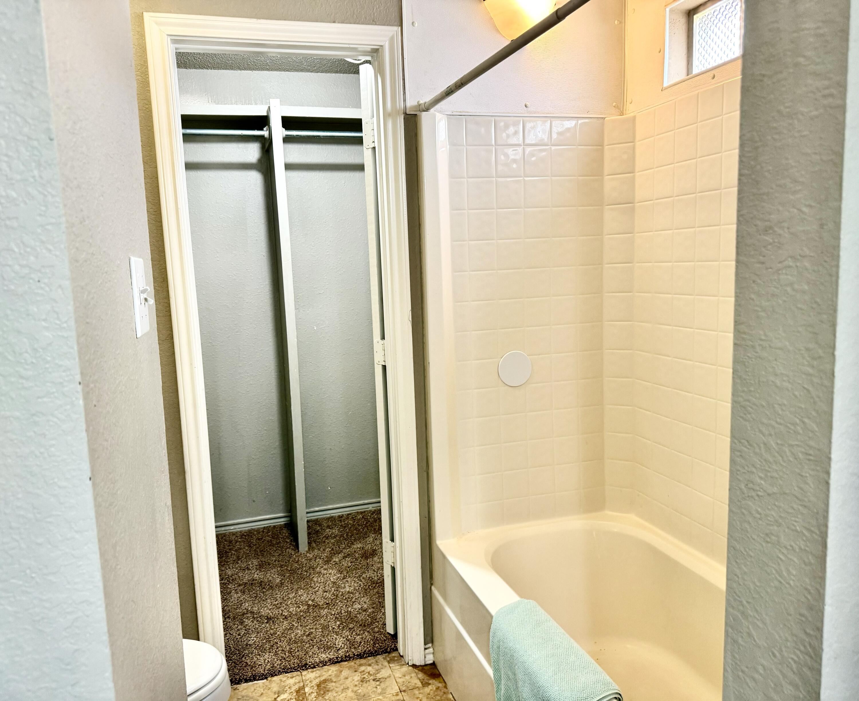 1918 75th Street Lubbock, TX 79423 - Photo 8 of 15 a bathroom with a bathtub and shower