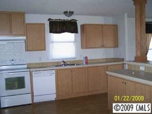 3310 Edwards Road Wingate, NC 28174 - Photo 2 of 5 a kitchen with sink cabinets and microwave
