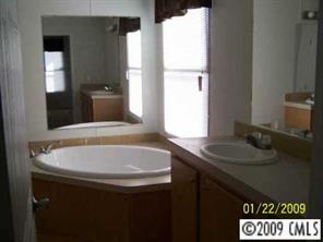 3310 Edwards Road Wingate, NC 28174 - Photo 4 of 5 a bathroom with a sink and a mirror