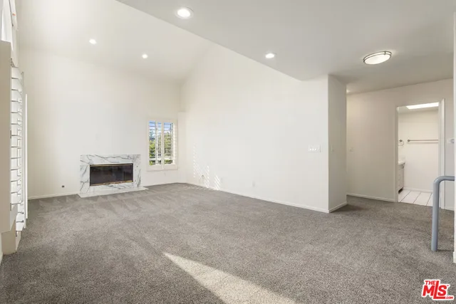 a view of an empty room with a fireplace