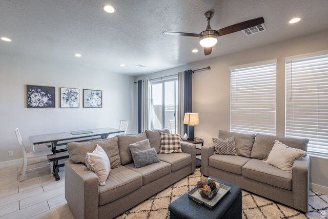 4845 Fishers Is Way St. George, UT 84770 - Photo 21 of 41 Living room with a textured ceiling, a ceiling fan, recessed lighting, and wood finished floors