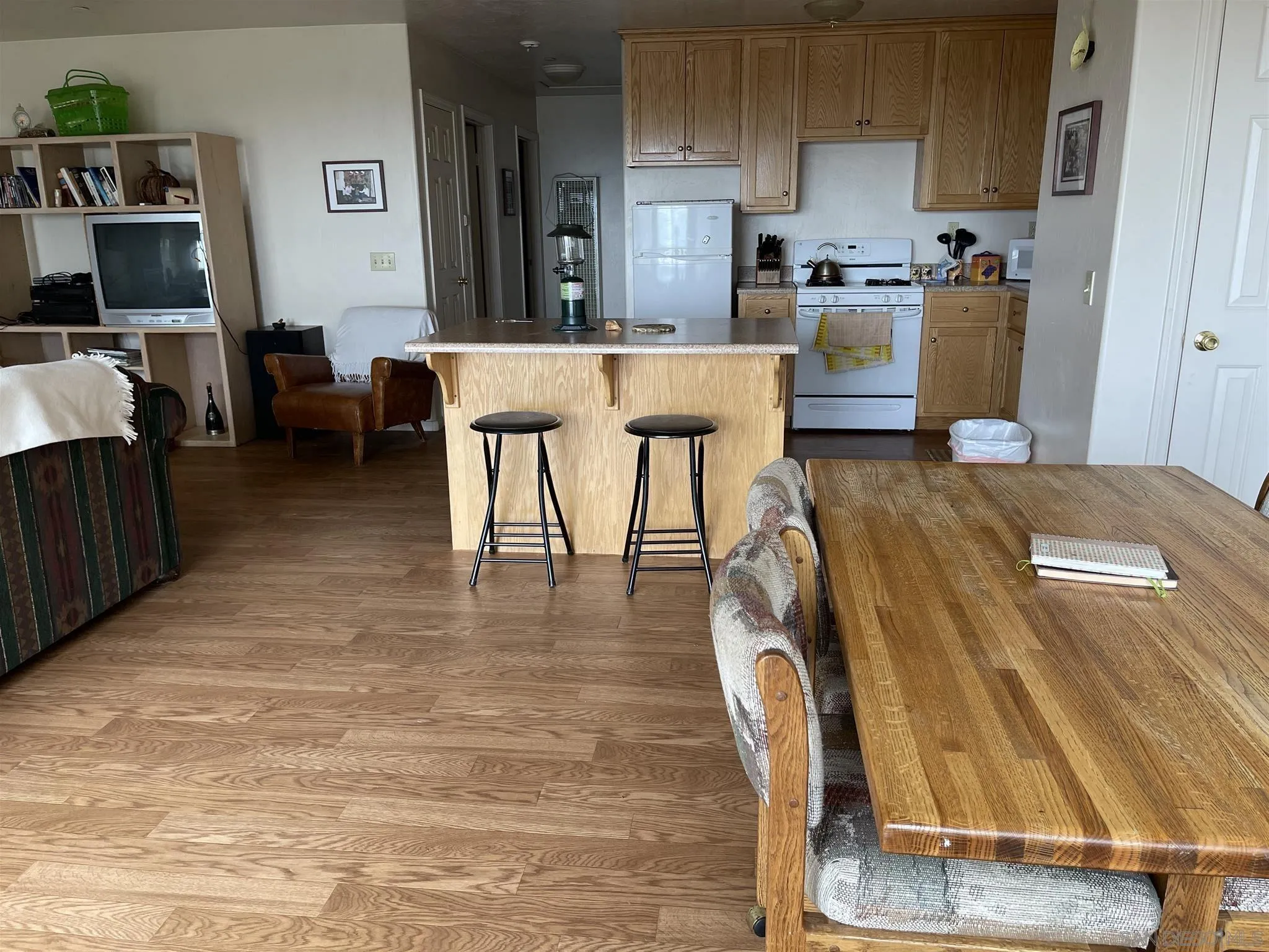 5885 Grandview Road Julian, CA 92036 - Photo 5 of 12 a living room with furniture and a dining table with kitchen view