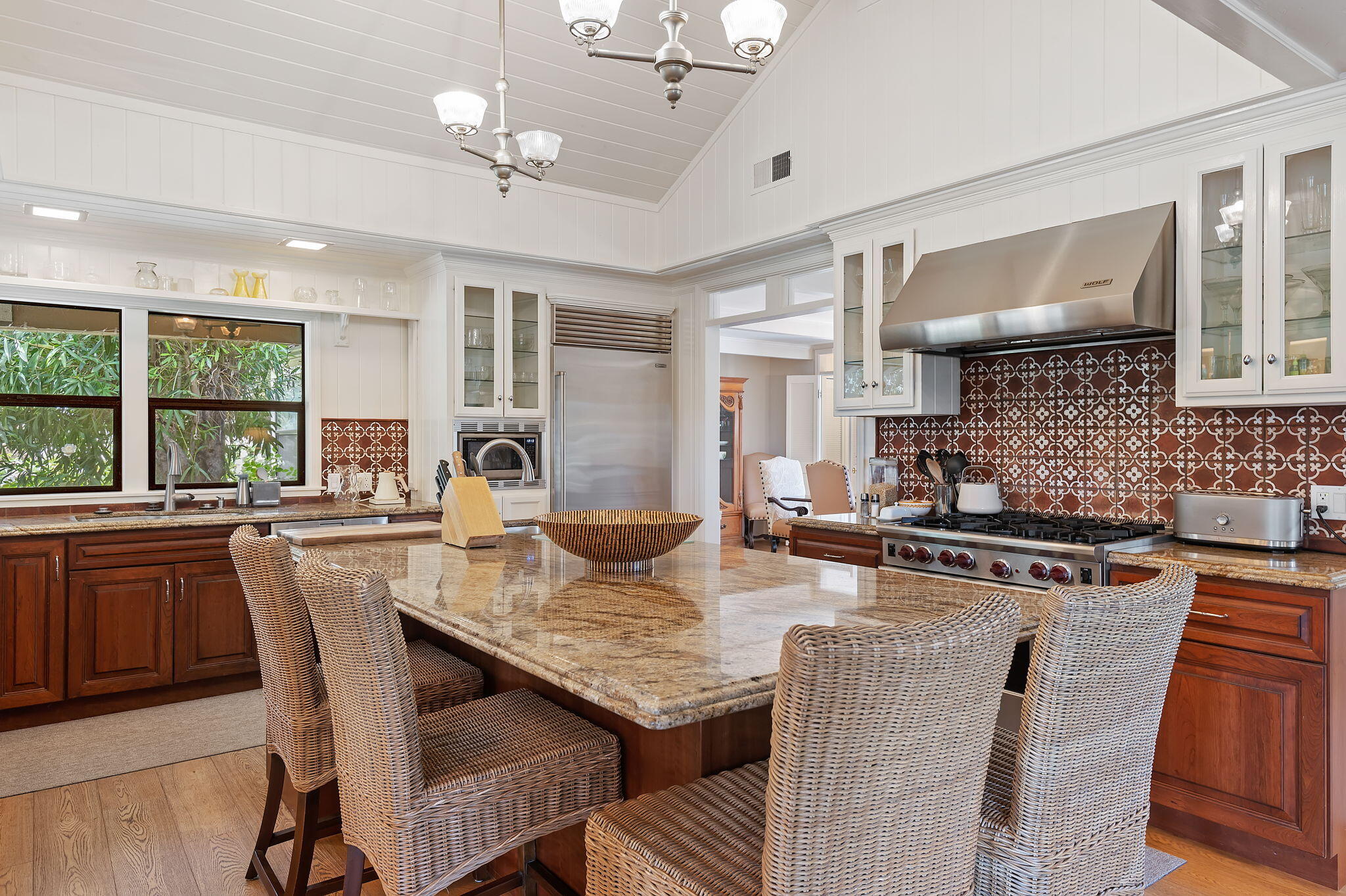 0 Still Meadow Road Solvang, CA 93463 - Photo 11 of 57 a kitchen with stainless steel appliances granite countertop a stove a sink dishwasher a dining table and chairs with wooden floor