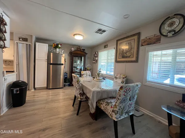 a kitchen with a sink a counter top space stainless steel appliances and a window