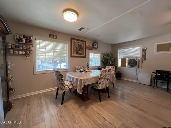 a kitchen with a sink stove and wooden floor