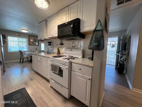 a kitchen with stove and cabinets