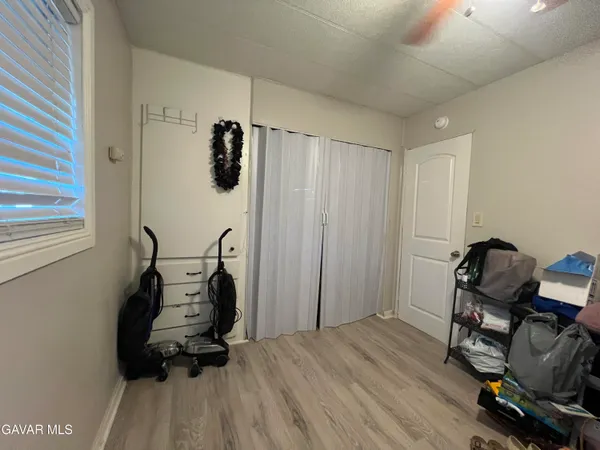 a bedroom with a bed and a television
