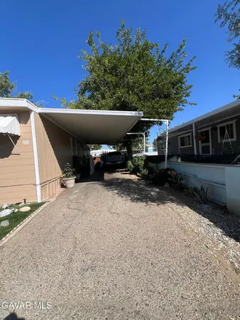 a view of house with outdoor space and car parked