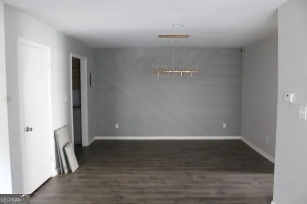 a view of a room with wooden floor
