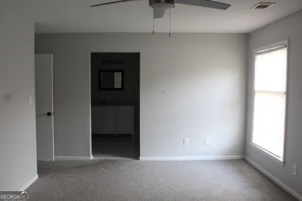 a view of an empty room with a window