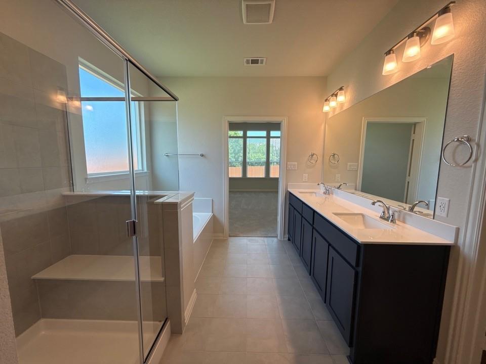 1233 Frio Drive Springtown, TX 76082 - Photo 10 of 13 Spacious bathroom with dual vanities featuring dark cabinetry and white countertops