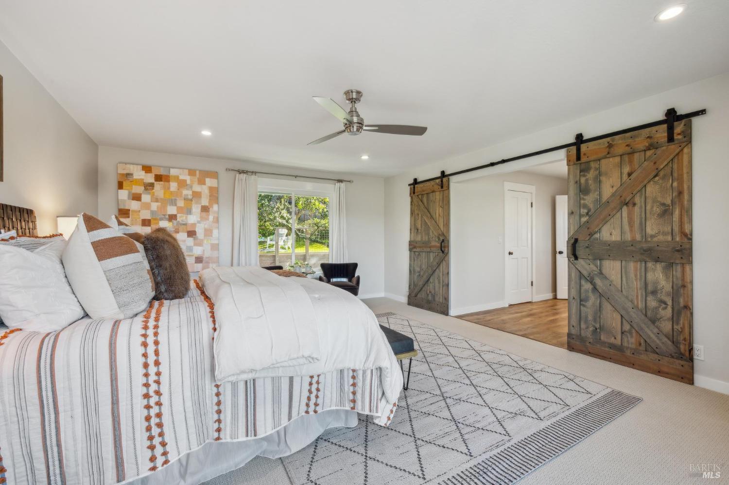 981 Greenhill Road Mill Valley, CA 94941 - Photo 36 of 91 a bedroom with a large bed and a chandelier
