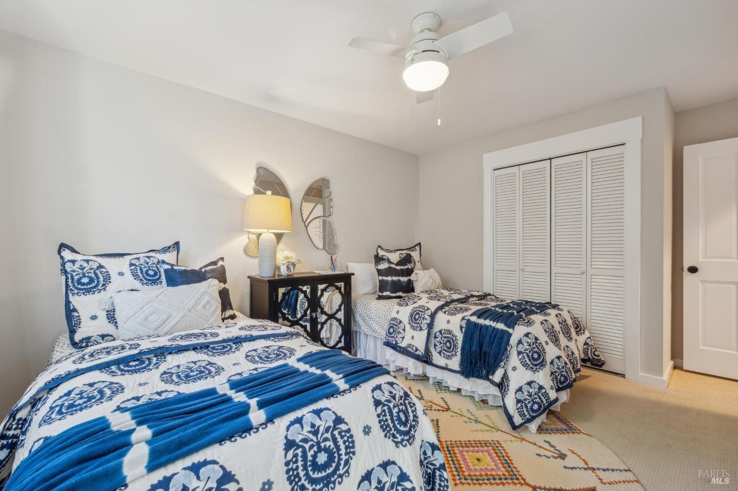 981 Greenhill Road Mill Valley, CA 94941 - Photo 43 of 91 a bed sitting in a bedroom next to a lamp with wooden floor