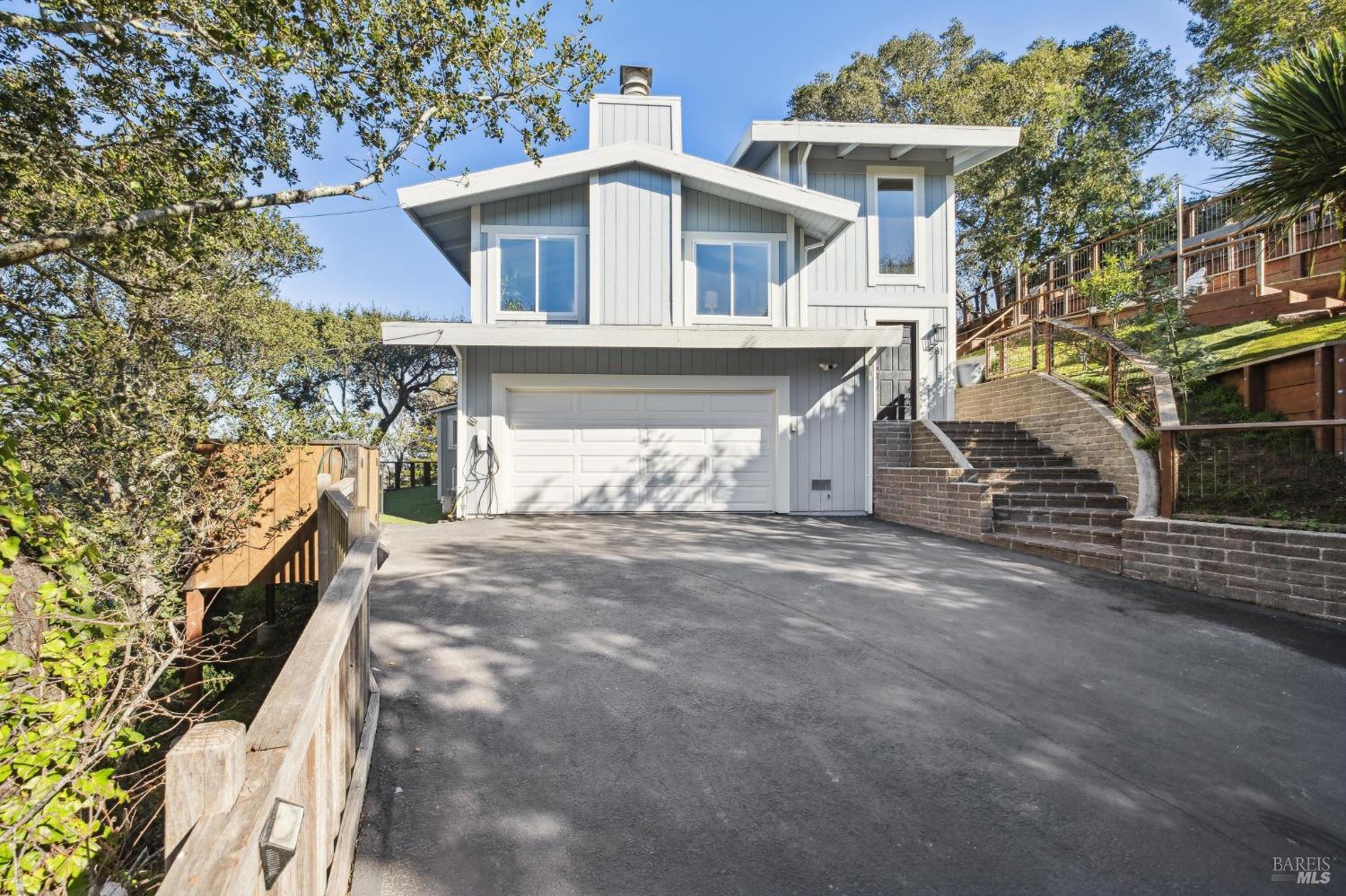 981 Greenhill Road Mill Valley, CA 94941 - Photo 6 of 91 a front view of a house with a yard and garage