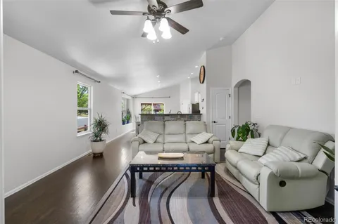 a living room with furniture and wooden floor