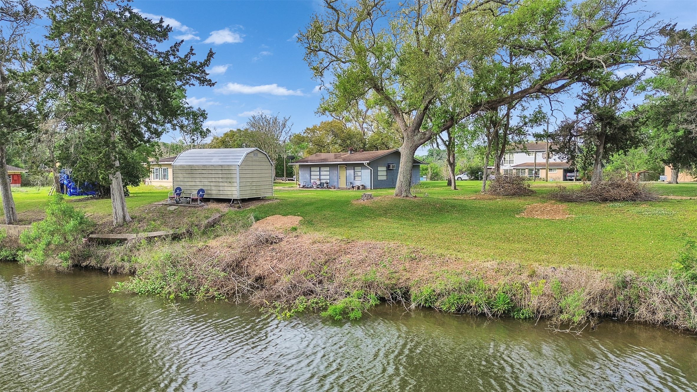 3315 St Anne Street Liverpool, TX 77577 - Photo 42 of 48 a view of a house with a yard and a large tree center island