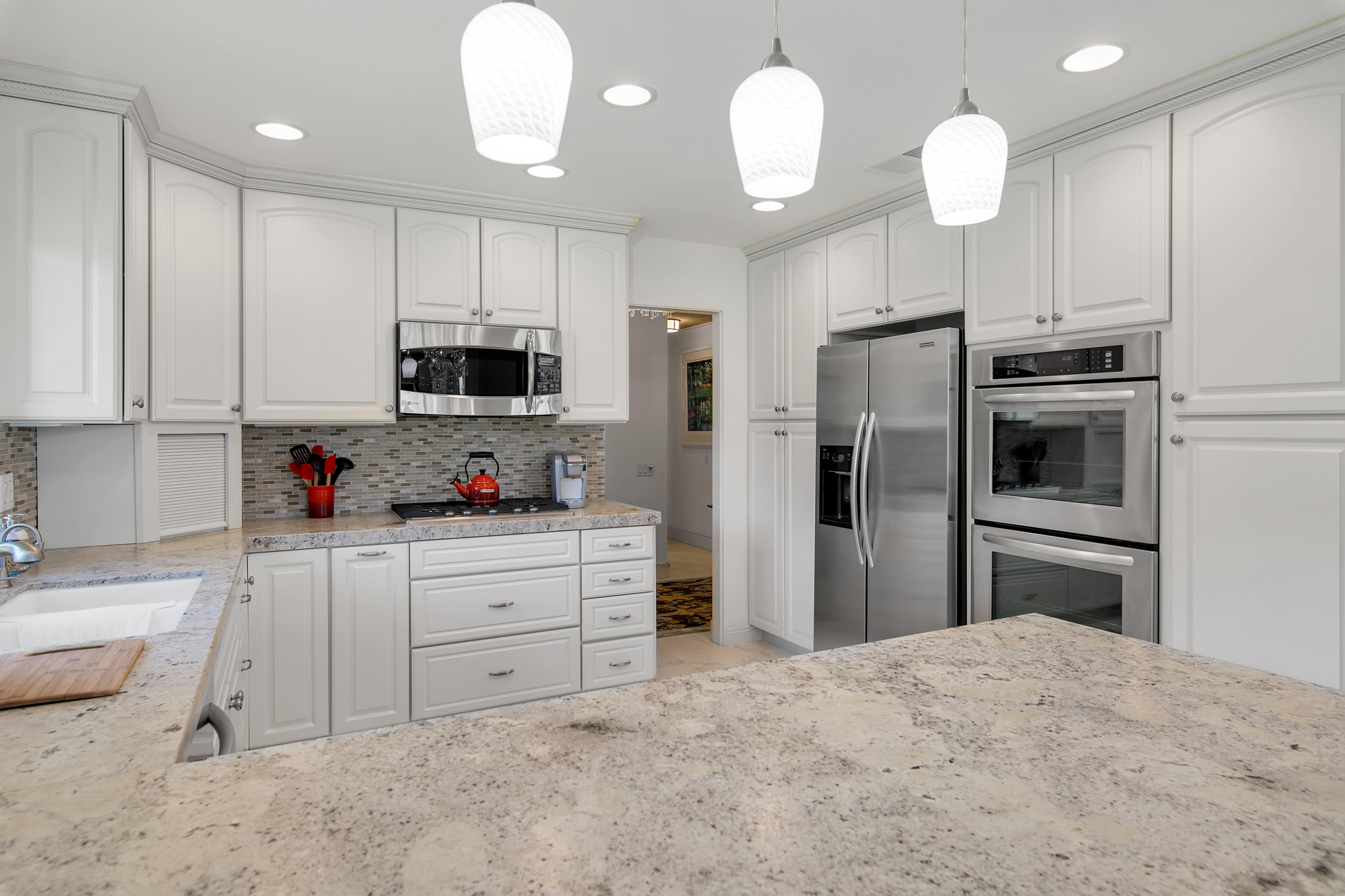 77920 Cherokee Road Indian Wells, CA 92210 - Photo 8 of 39 a kitchen with stainless steel appliances a refrigerator sink and microwave