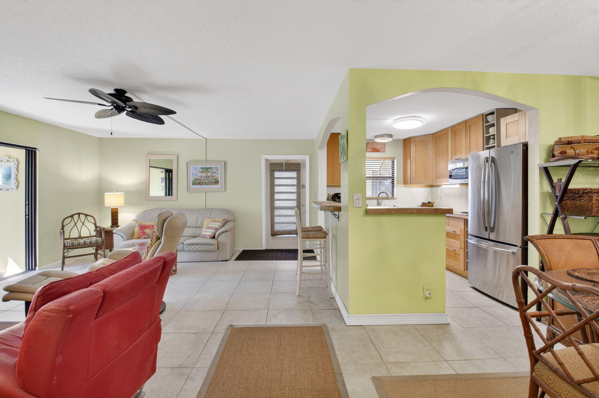501 Dotterel Road, Unit 26B Delray Beach, FL 33444 - Photo 23 of 48 a living room with furniture a flat screen tv and a refrigerator