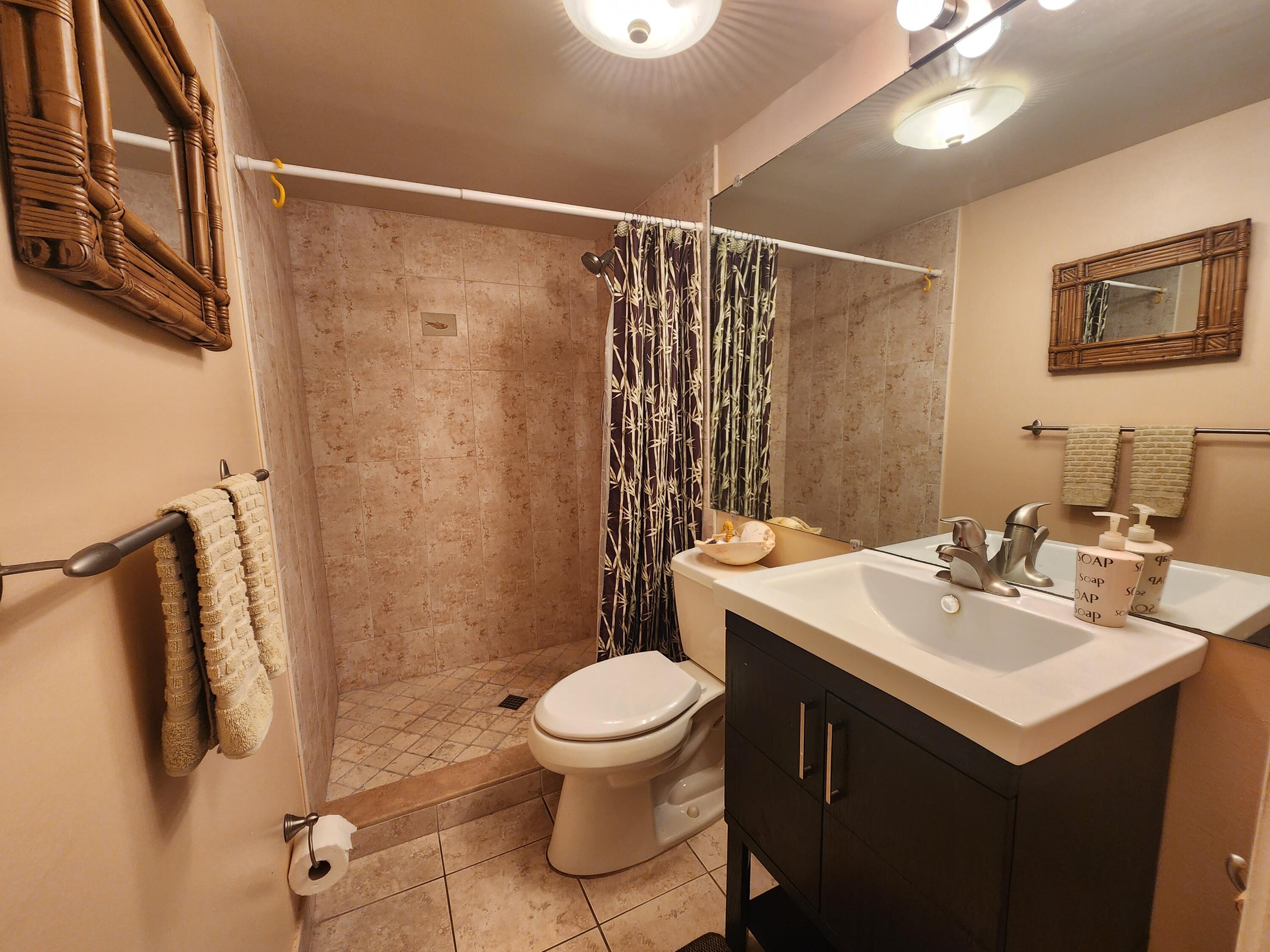 501 Dotterel Road, Unit 26B Delray Beach, FL 33444 - Photo 27 of 48 a bathroom with a sink toilet and shower