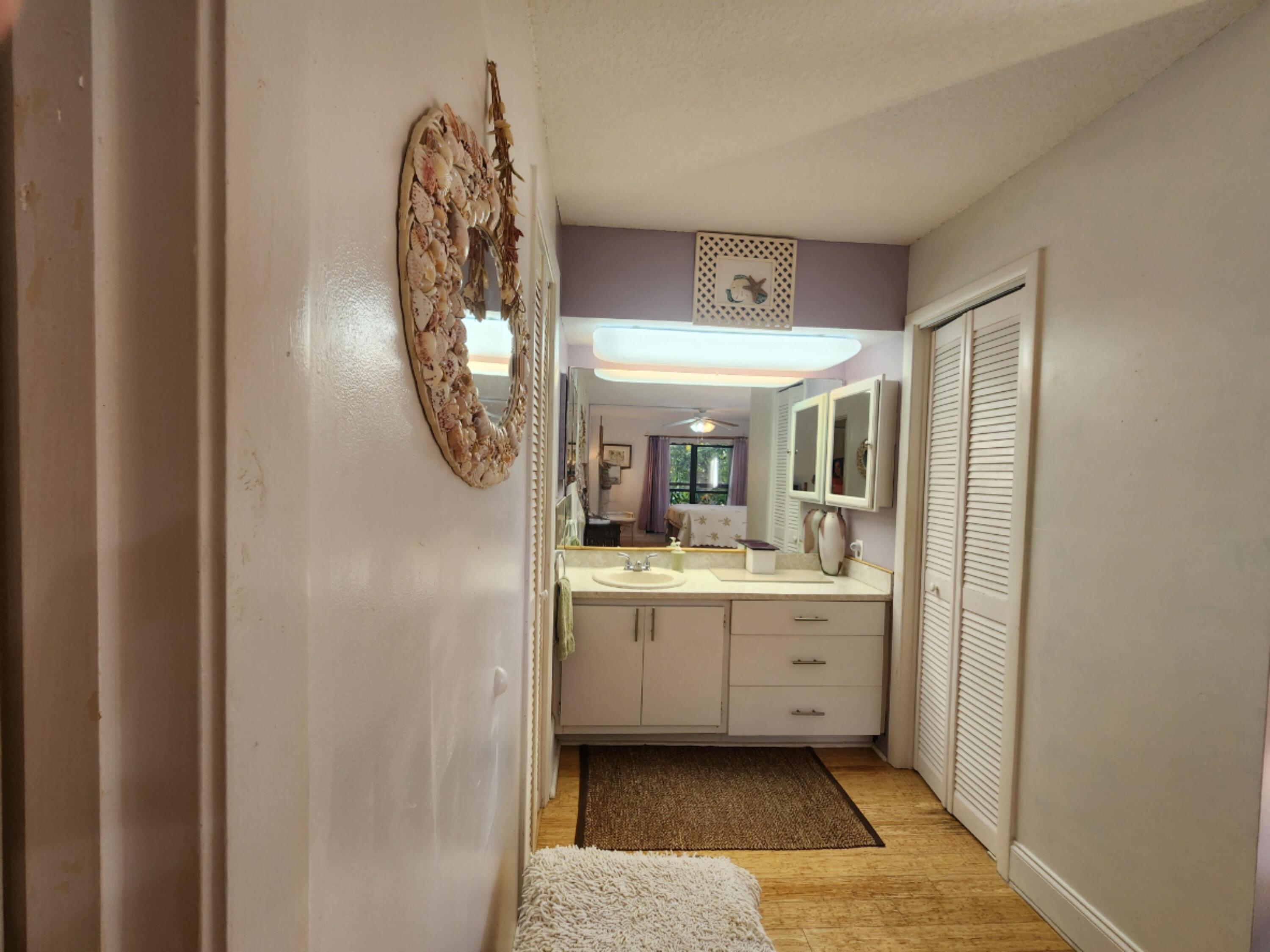 501 Dotterel Road, Unit 26B Delray Beach, FL 33444 - Photo 30 of 48 a bathroom with a sink and a mirror