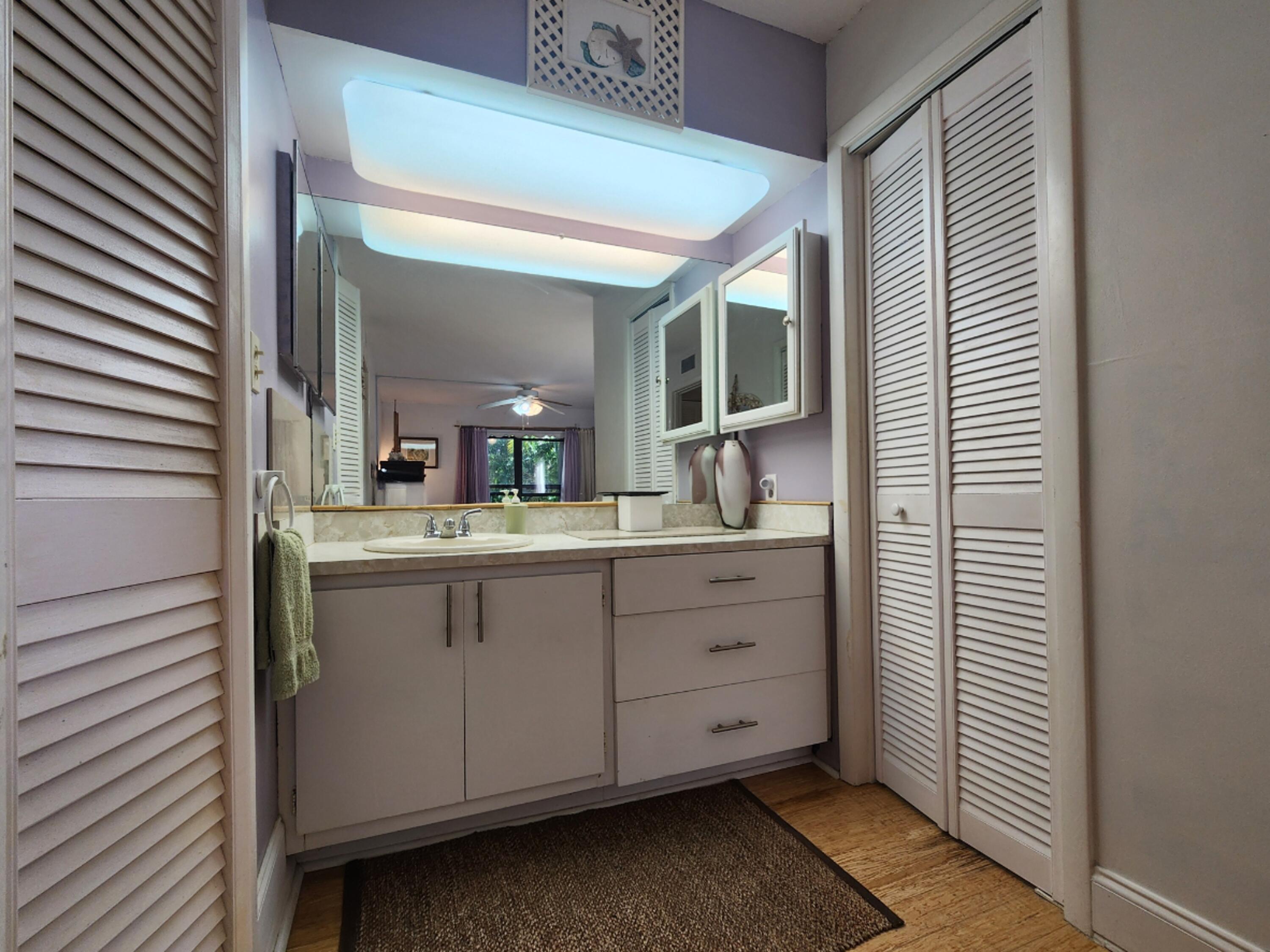 501 Dotterel Road, Unit 26B Delray Beach, FL 33444 - Photo 31 of 48 a bathroom with a sink and a mirror