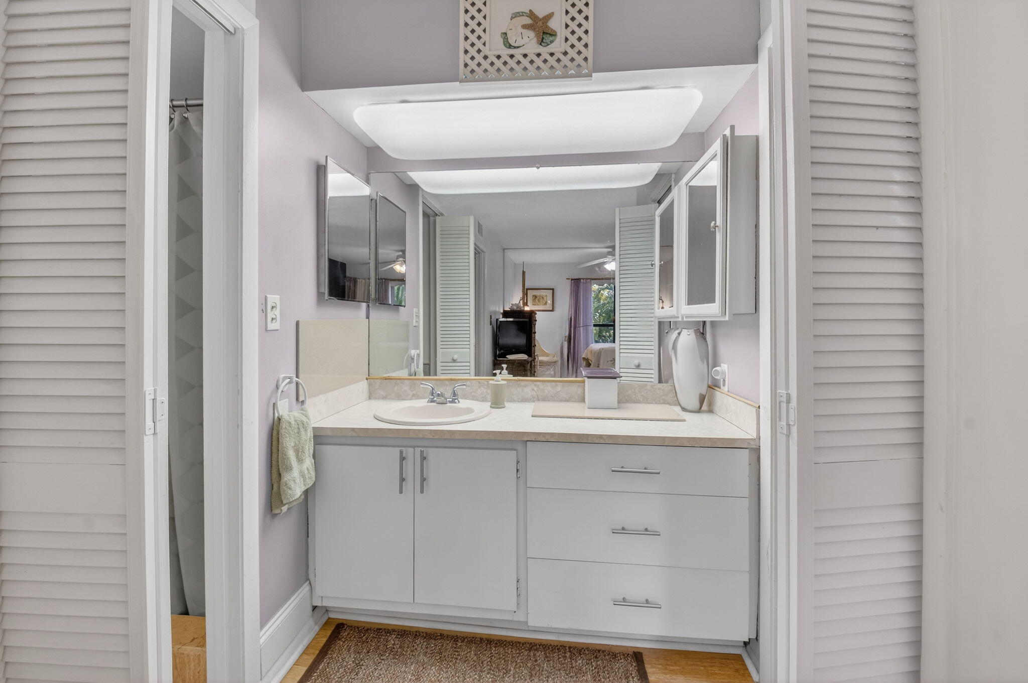 501 Dotterel Road, Unit 26B Delray Beach, FL 33444 - Photo 32 of 48 a bathroom with a sink and a mirror