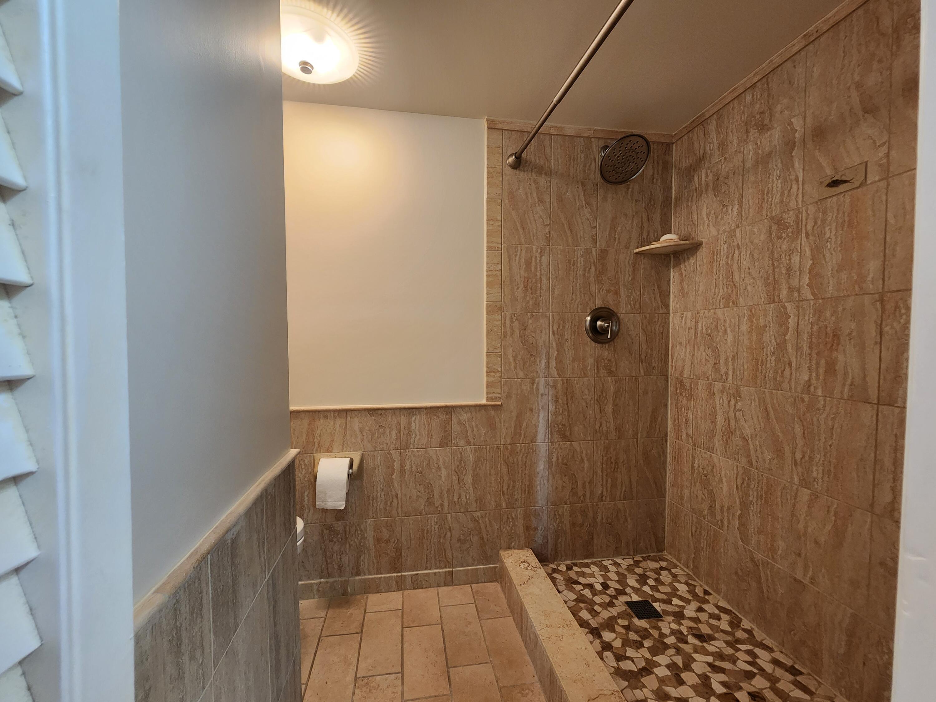 501 Dotterel Road, Unit 26B Delray Beach, FL 33444 - Photo 34 of 48 a bathroom with a shower