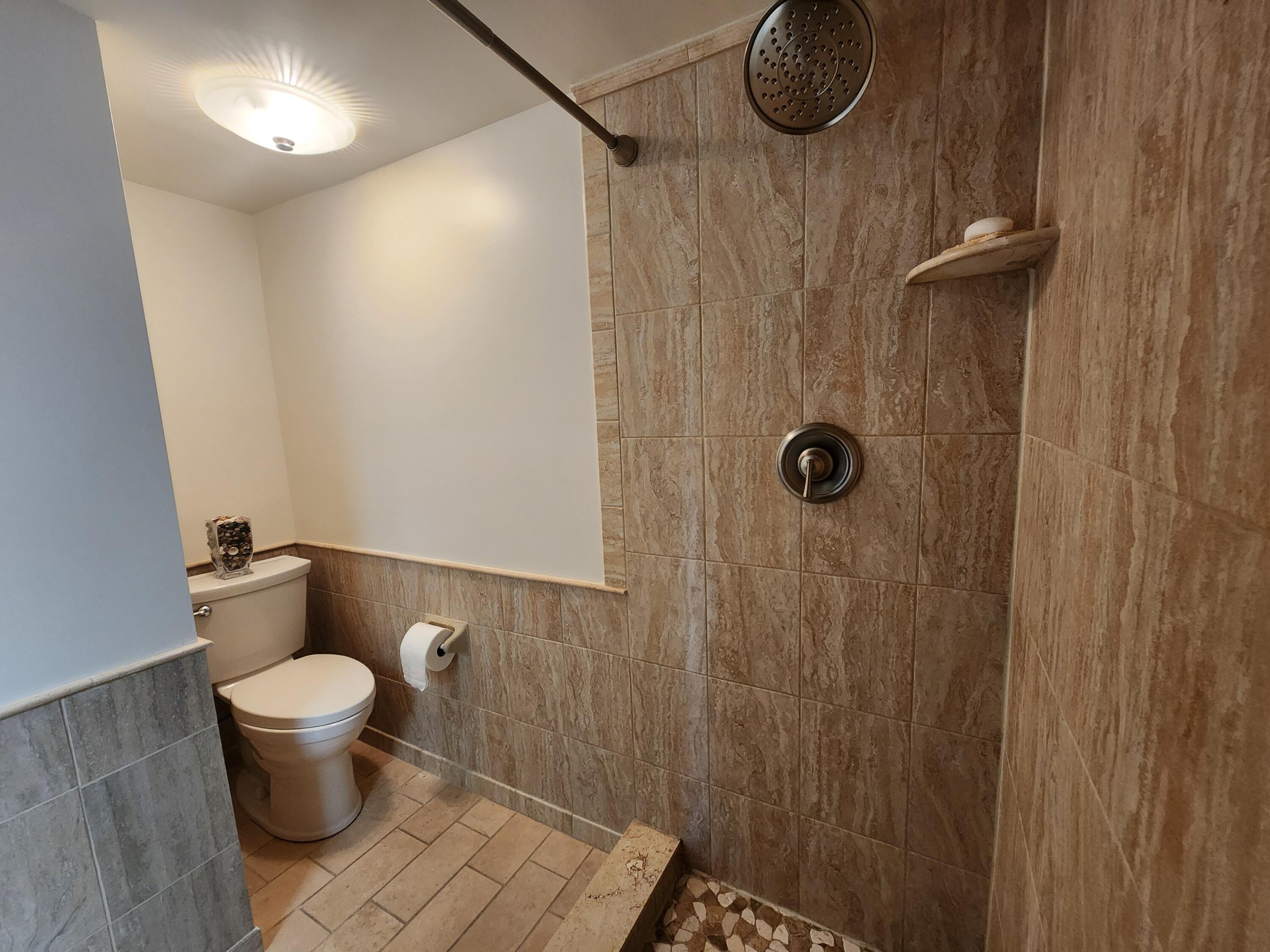 501 Dotterel Road, Unit 26B Delray Beach, FL 33444 - Photo 35 of 48 a bathroom with a toilet and a shower