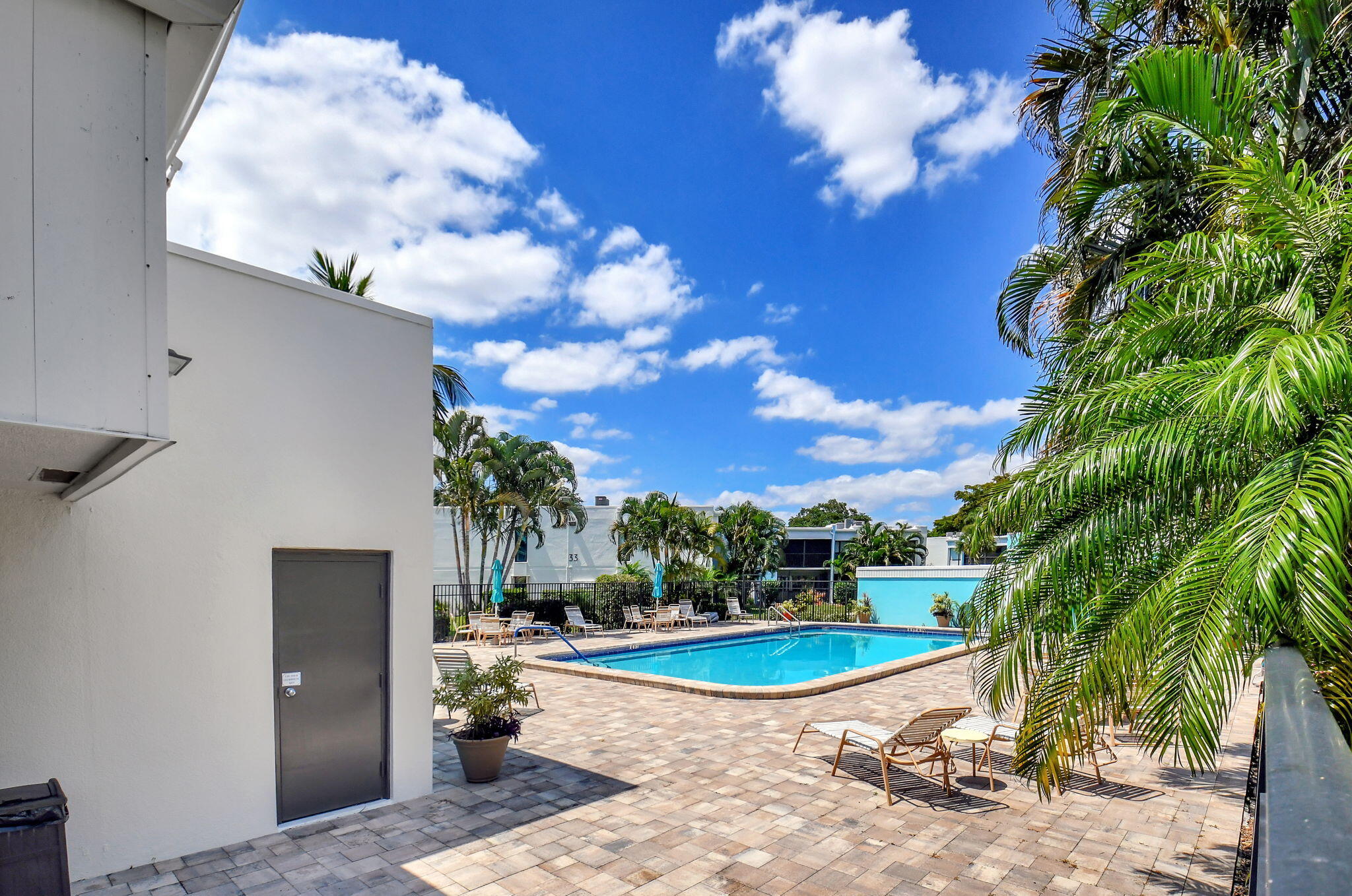 501 Dotterel Road, Unit 26B Delray Beach, FL 33444 - Photo 44 of 48 a view of a swimming pool with a yard