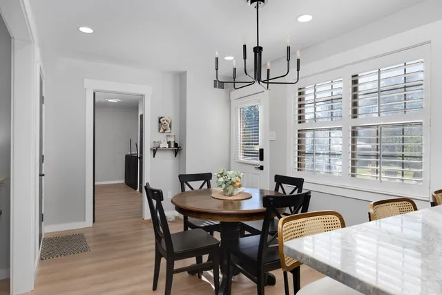 a view of a dining room with furniture window and wooden floor