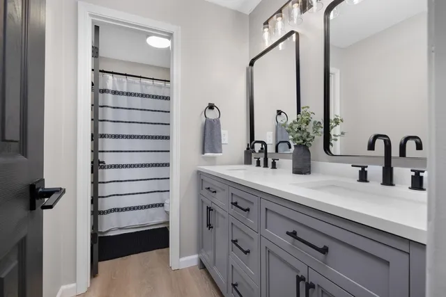 a bathroom with a double vanity sink and mirror