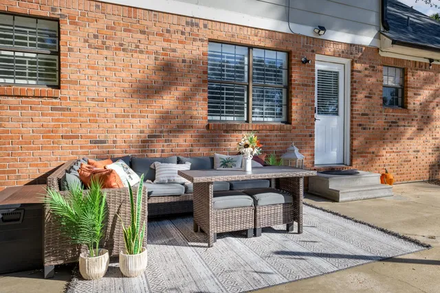 a terrace of a house with outdoor seating