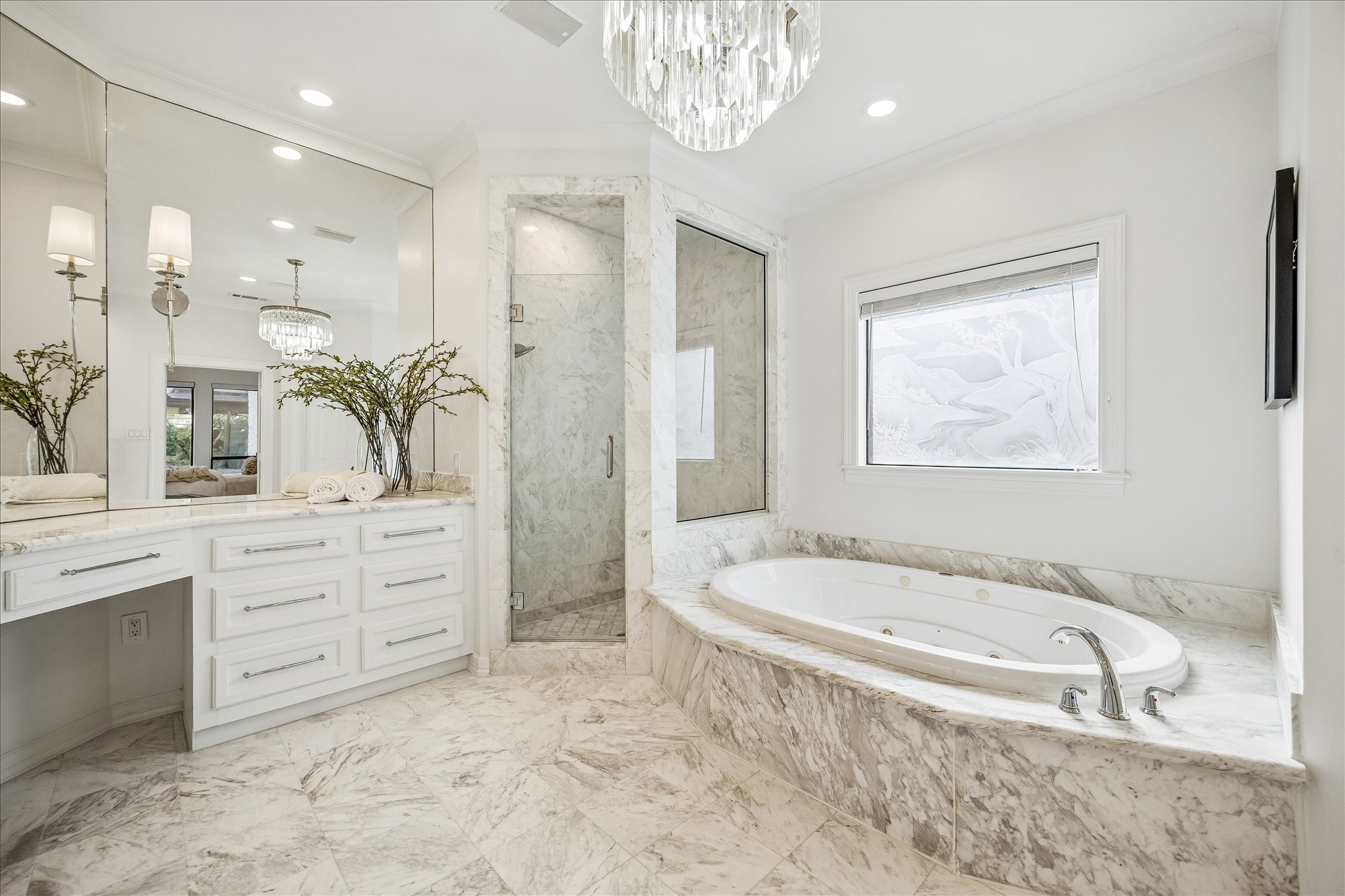 4614 Spruce Street Bellaire, TX 77401 - Photo 19 of 30 a bathroom with a granite countertop tub a sink and a large mirror