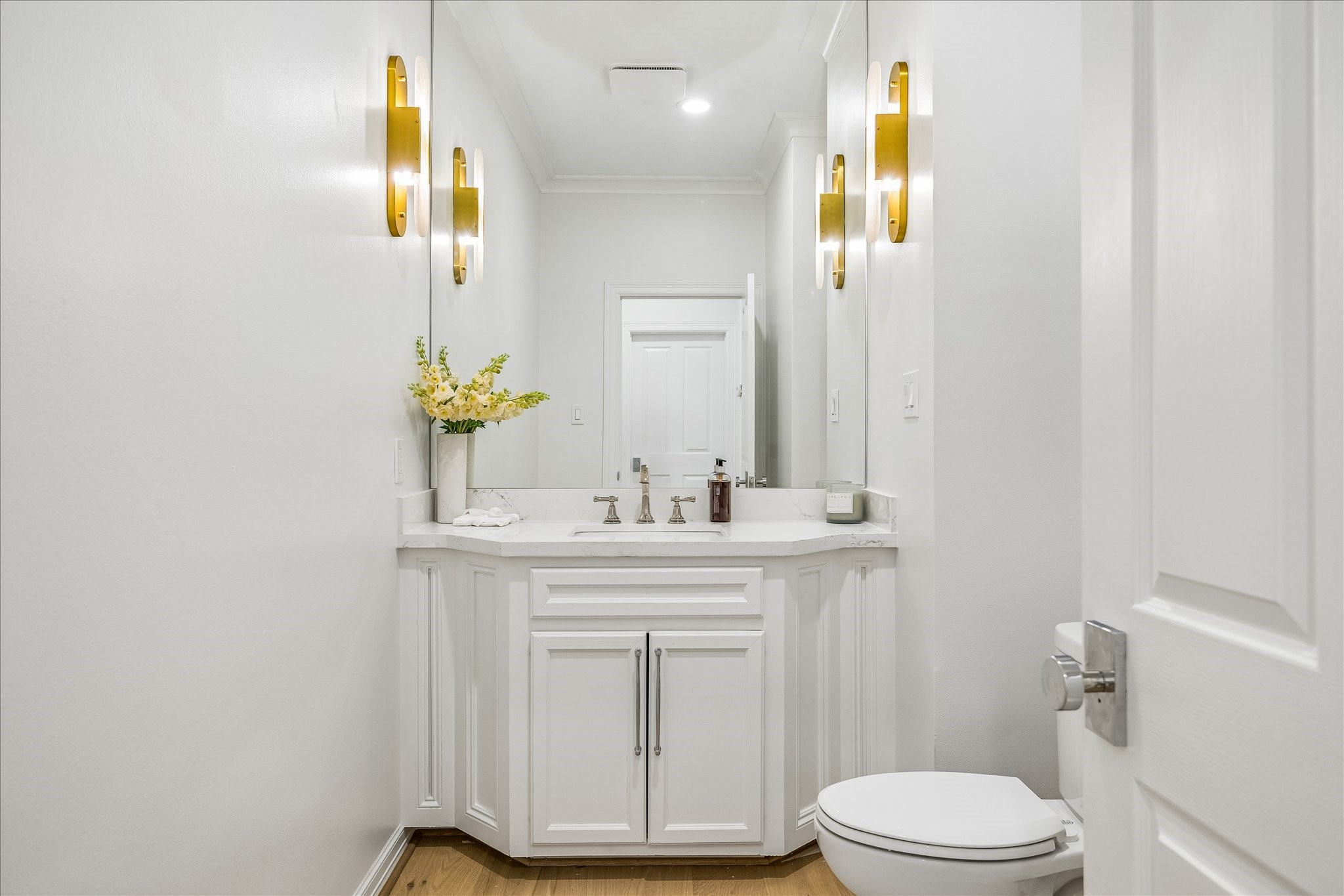 4614 Spruce Street Bellaire, TX 77401 - Photo 21 of 30 a bathroom with a sink a toilet and a mirror